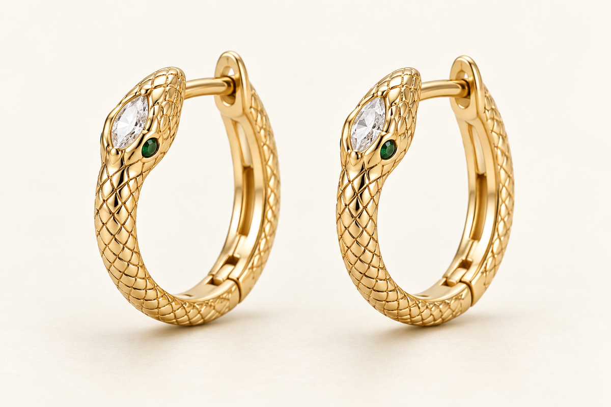 Zambezi Emerald-Eye Serpent Hoops, gold-finished snake earrings with clear crystals and green eye accents