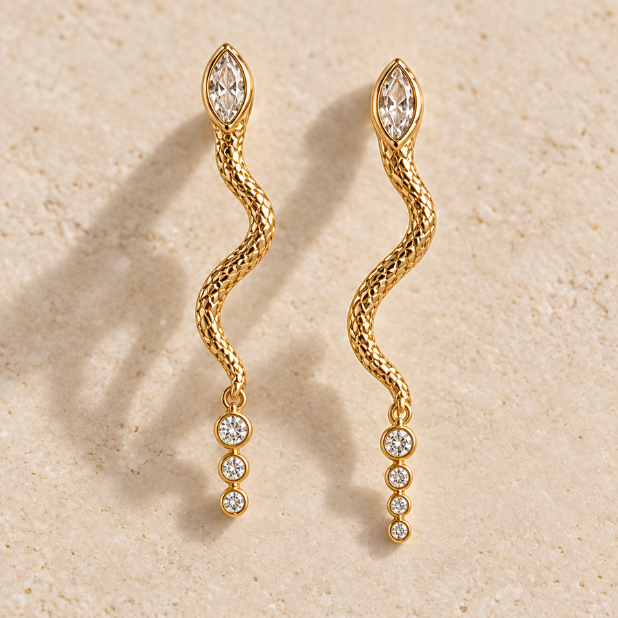Apsara Trinity Serpent Earrings, matching gold-finished snake drops with marquise and three round clear crystals