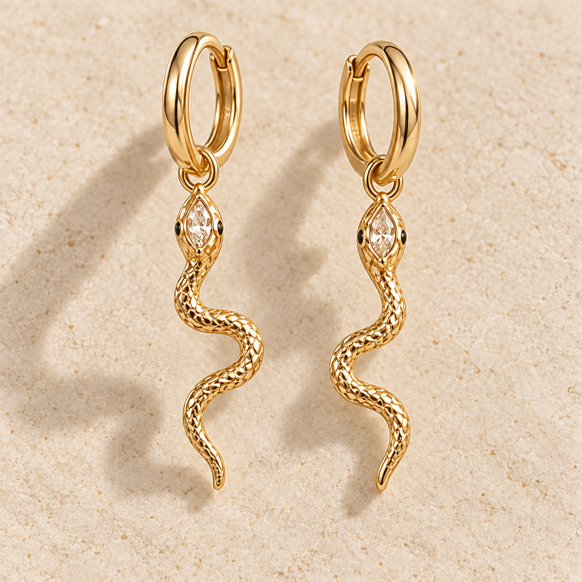 Naia Serpent Huggie Drops, gold-finished hoop earrings with clear crystal snake charms