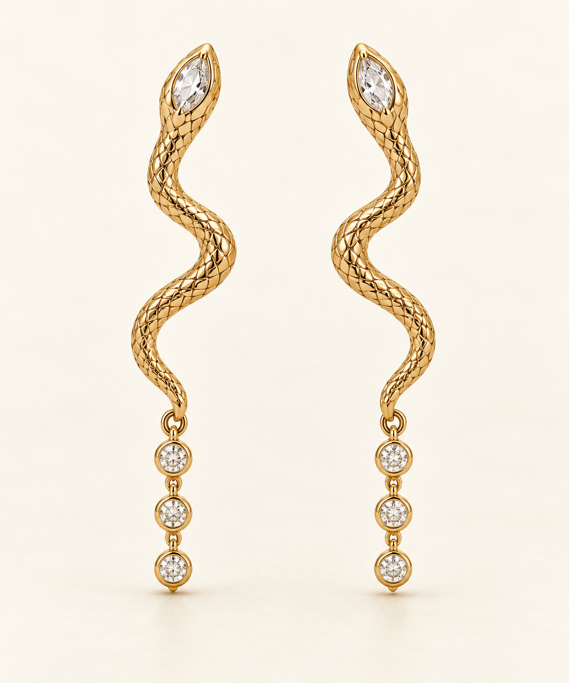 Moirai Asymmetric Serpent Earrings, gold-finished snake drops with three- and four-crystal tails