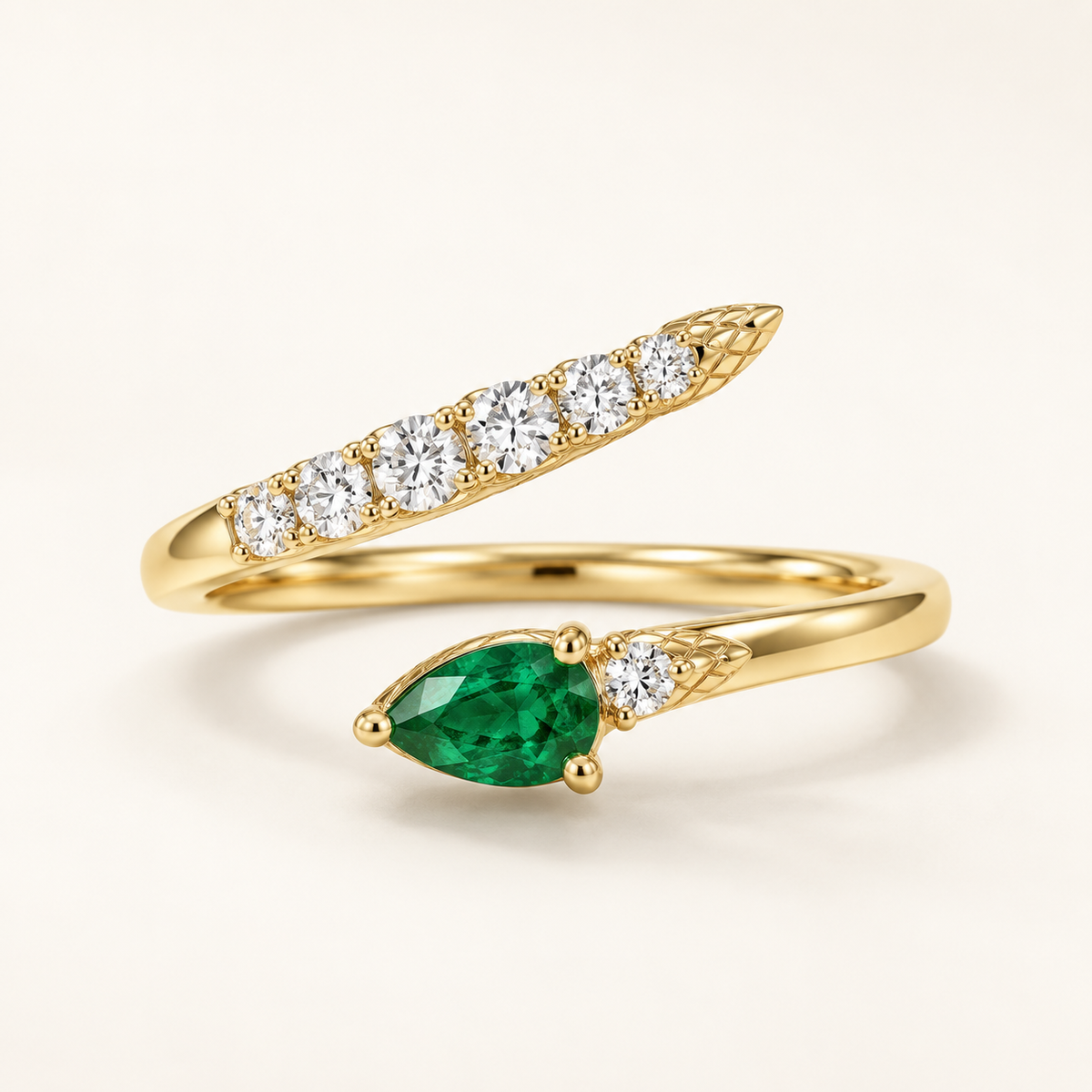 Basilisk Emerald-Tear Bypass Ring, gold-finished ring with a pear-shaped green stone and graduated clear crystals